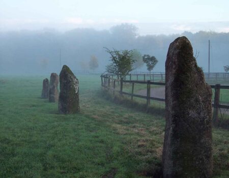 Row of glacial granite monoliths at misty dawn