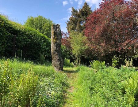 Tall Cornish granite finger stone in a private garden