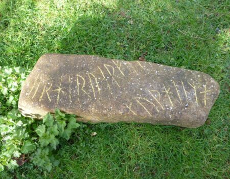 Hand carved runes with gold leaf on flat limestone boulder