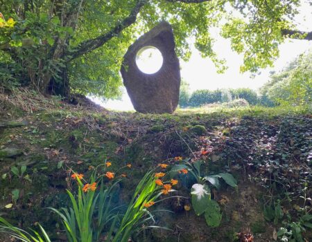 Cornish granite holed stone in a wooded glade